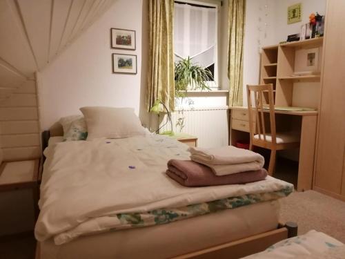 1 dormitorio con 1 cama con toallas en Ferienhaus Hooksiel, en Hooksiel
