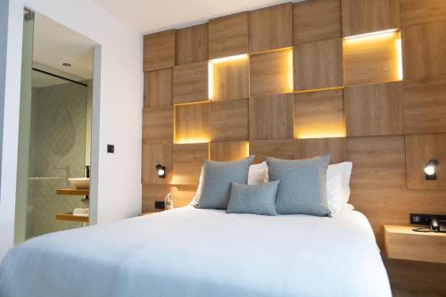 a bedroom with a large bed and wooden wall at Old Port Hotel in Limassol