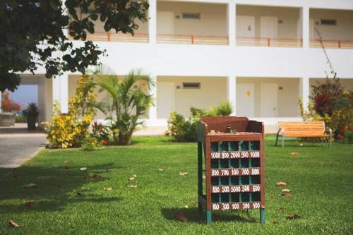 a sign in the grass in front of a building at San Agustin Paracas in Paracas