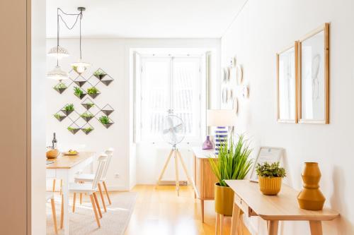 a living room with a table and a dining room at ALTIDO Chiado Self Check-In 2-BR Flat with Parking in Lisbon