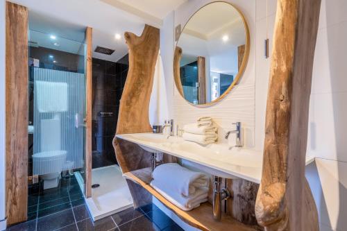 a bathroom with a sink and a shower and a mirror at Hotel Una in Brighton & Hove