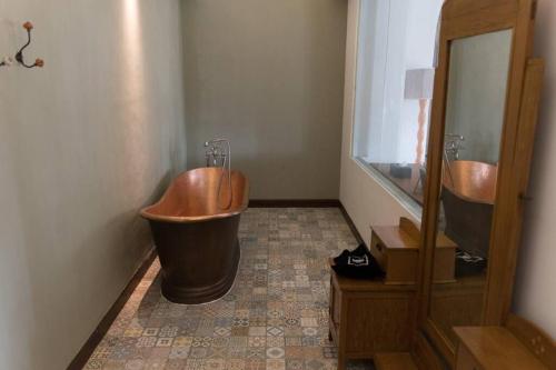 a bathroom with two sinks and a large tub at Exotic Chamber in Malang