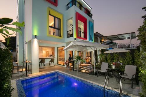 a house with a swimming pool in front of a house at Viryla Boutique Hotel in Vientiane