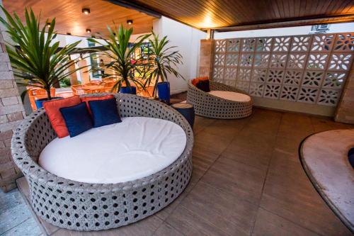 a room with a wicker chair on a balcony at Hotel Morada do Sol in Caldas Novas