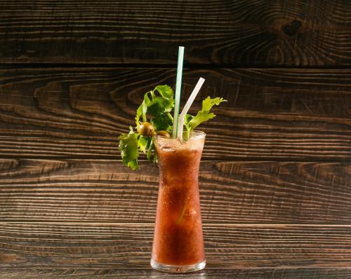 a drink in a glass with greens in it at Viryla Boutique Hotel in Vientiane