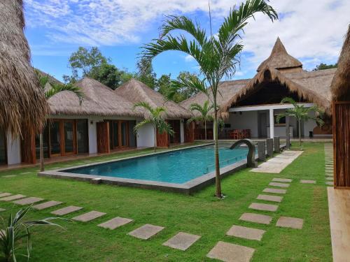 a villa with a swimming pool in a resort at SAMADHI Resort & Hydrospa Panglao in Panglao