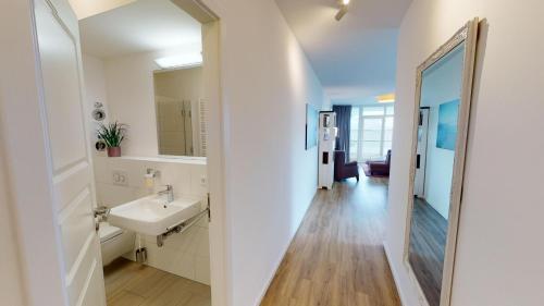 a bathroom with a sink and a mirror at Südkap E-04 in Pelzerhaken