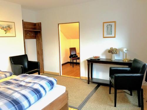 a bedroom with a bed and a desk and a mirror at City Apartments in Osterholz-Scharmbeck