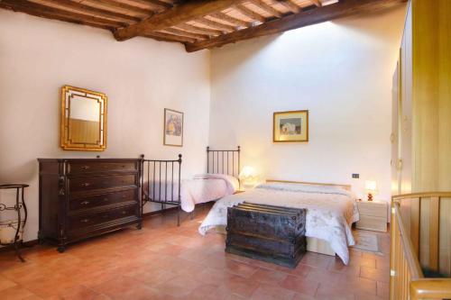 a bedroom with a bed and a dresser and a mirror at Iris in Poggibonsi