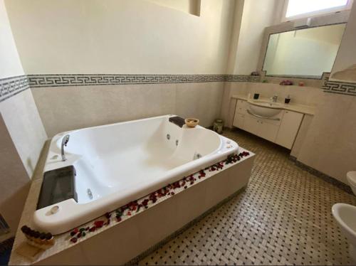 a bathroom with a bath tub and a sink at Alla dimora di Chiara Suite and Rooms in Matera