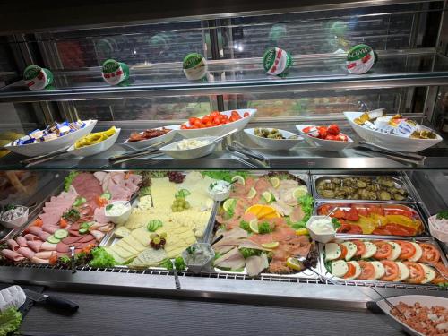 a display case with many different types of food at Hotel Bispinger Hof in Bispingen