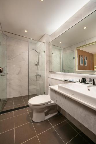 a bathroom with a toilet and a sink and a shower at Viryla Boutique Hotel in Vientiane
