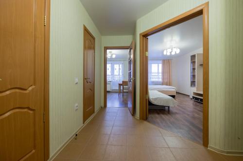 a hallway with a room with a bed and a mirror at OK! Советская, 69 №1 in Tomsk