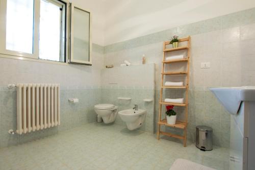 a bathroom with a toilet and a sink at Salento Inside in Morciano di Leuca