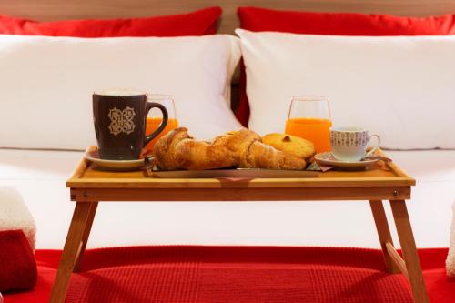 a tray of pastries and orange juice on a table at Salento Inside in Morciano di Leuca