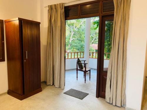 a room with a sliding glass door to a balcony at Villa 45 - Balapitiya in Balapitiya