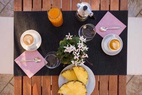 a table with a plate of food and orange juice at Salento Inside in Morciano di Leuca