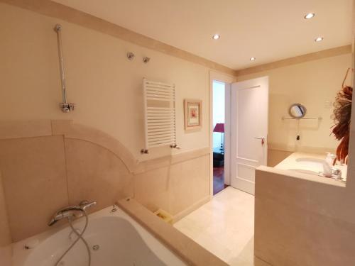 a bathroom with a tub and a sink at Entire floor parque nacoes prime apartments expo30 in Lisbon