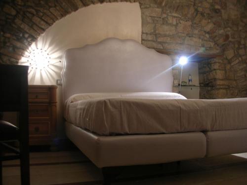 a bedroom with a bed with a light on it at La Cantina del Convento in Potenza