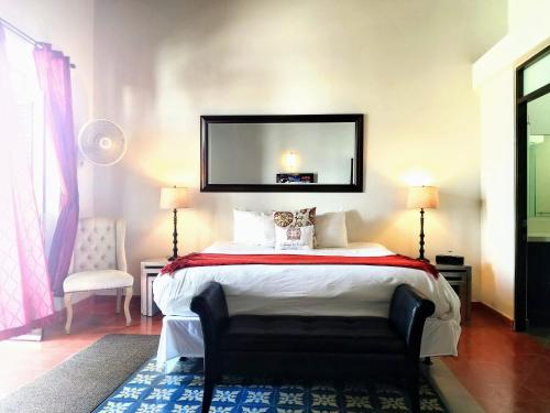 a bedroom with a bed with a mirror on the wall at La Terraza de San Juan in San Juan