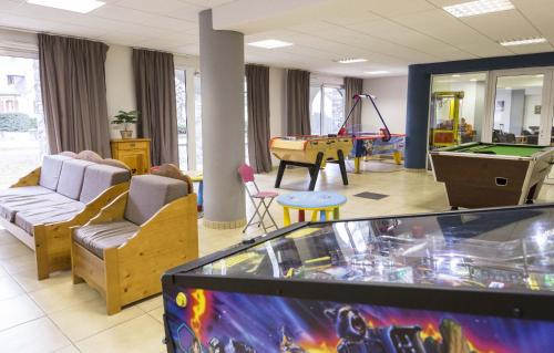 a living room with a pool table and a game room at Résidence Odalys Soleil d'Aure in Saint-Lary-Soulan