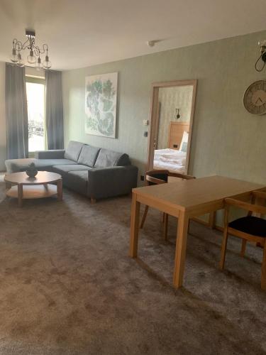 a living room with a couch and a table at PROSECCO RESIDENCE MARKO in Valtice