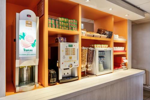 a store shelf with several appliances in a store at Premiere Classe Vannes in Vannes