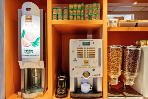 a shelf with a coffee maker and a food processor at Premiere Classe Vannes in Vannes