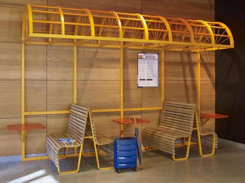 a bunk bed with two chairs and a table at ibis Styles Warszawa City in Warsaw