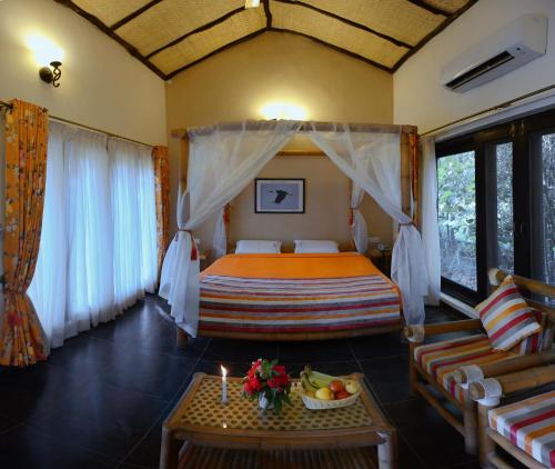 a bedroom with a bed and a table with a candle at Aranyak Resort in Tāla