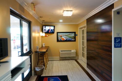 a hallway with a door and a tv on the wall at Howard Johnson by Wyndham Salinas in Salinas