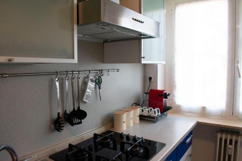 a kitchen with a sink and a stove top at J&M HOUSE -Fronte Ospedale- in Udine