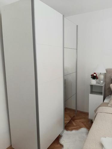 a sliding glass closet door in a bedroom at Apartman Miletic in Mostar