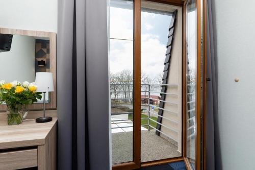 a glass door leading into a room with a balcony at Nawigator SPA in Rewal
