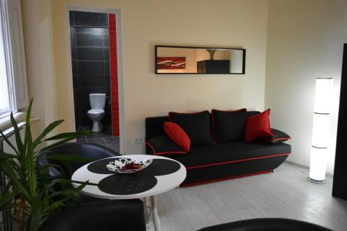 a living room with a couch and a table at Főtér Apartmanház Szentendre in Szentendre