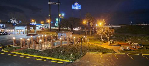 a parking lot with a gas station at night at THE COUNTRY CORNER INN in Devine