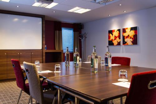 a conference room with a table with bottles of wine at Holiday Inn Express Stoke-On-Trent by IHG in Stoke on Trent