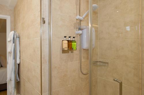 a bathroom with a shower with a glass door at Hillside Studio in Penzance