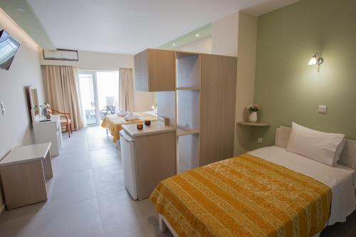 a hotel room with two beds and a kitchen at Chrisi Akti in Nafpaktos