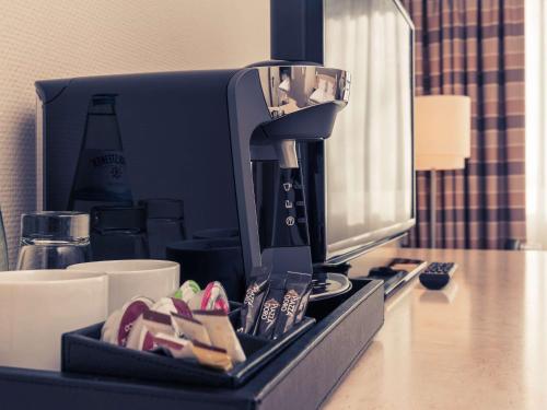 a coffee maker sitting on top of a counter at Mercure Hotel Bielefeld Johannisberg in Bielefeld