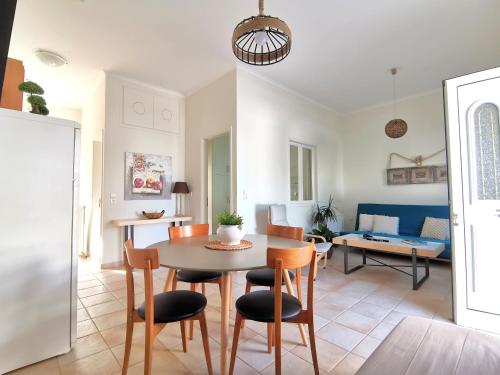 a dining room and living room with a table and chairs at Rena House in Kissamos