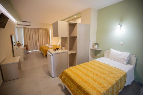 a hotel room with a bed and a desk in it at Chrisi Akti in Nafpaktos