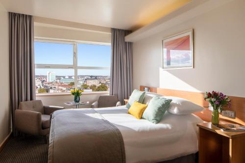 a hotel room with a bed and a window at St Giles London – A St Giles Hotel in London