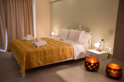 a bedroom with a large bed with towels on it at Chrisi Akti in Nafpaktos