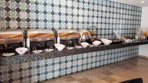a counter with bowls and utensils on it at Hotel Catedral La Paz in La Paz