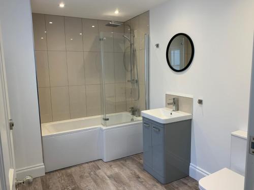 a bathroom with a tub and a sink and a shower at Amazing Luxury Beach Front Apartment in Margate