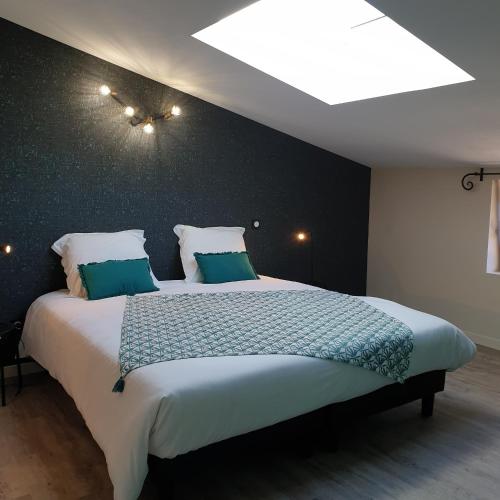 a bedroom with a large bed with a ceiling at Mas de Reilhanette in Montbrun-les-Bains