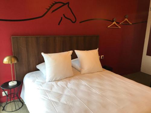 a bedroom with a bed with a horse on the wall at Sure Hotel by Best Western Argentan in Argentan