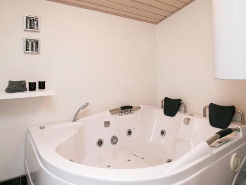 uma grande banheira branca num quarto em 6 person holiday home in Bl vand em Blåvand