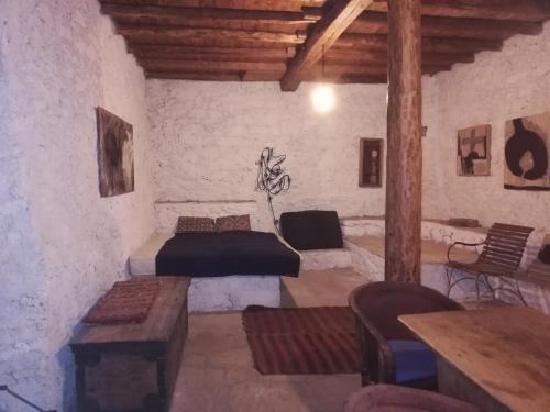 a room with two beds and a table and chairs at The traditional hause with the best view in Leonidion